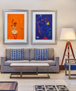 Couch with orange and blue artwork behind