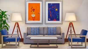 Couch in lobby with orange and blue artwork behind