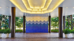 Exterior entry with large ocean wave-like decorative wall